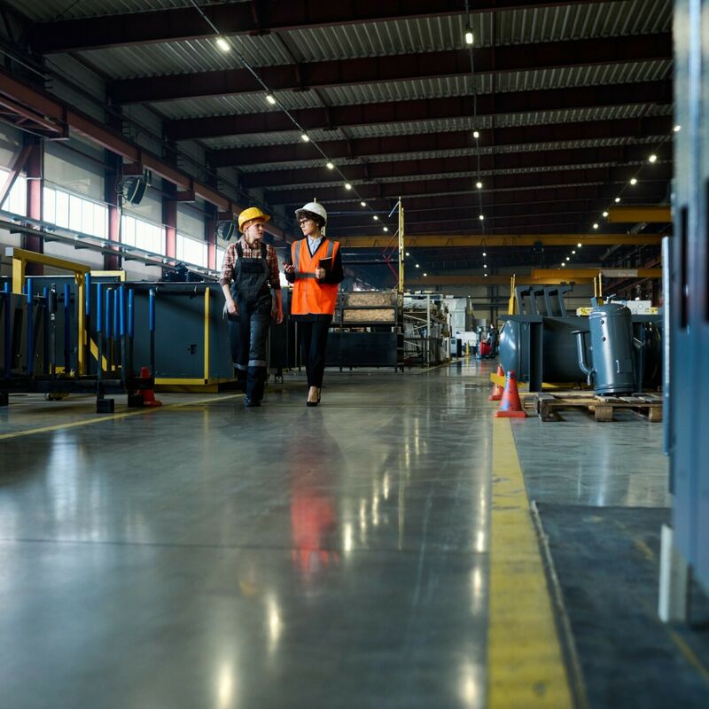 Young engineers of modern factory of solar battery production having talk